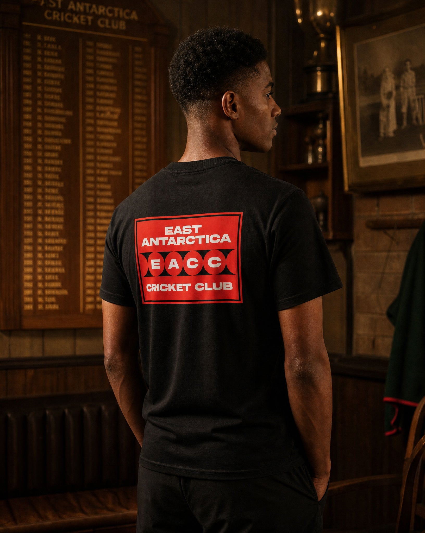 East Antarctica Cricket Club t shirt worn by male model in cricket club with honours board — PERAMA Federations