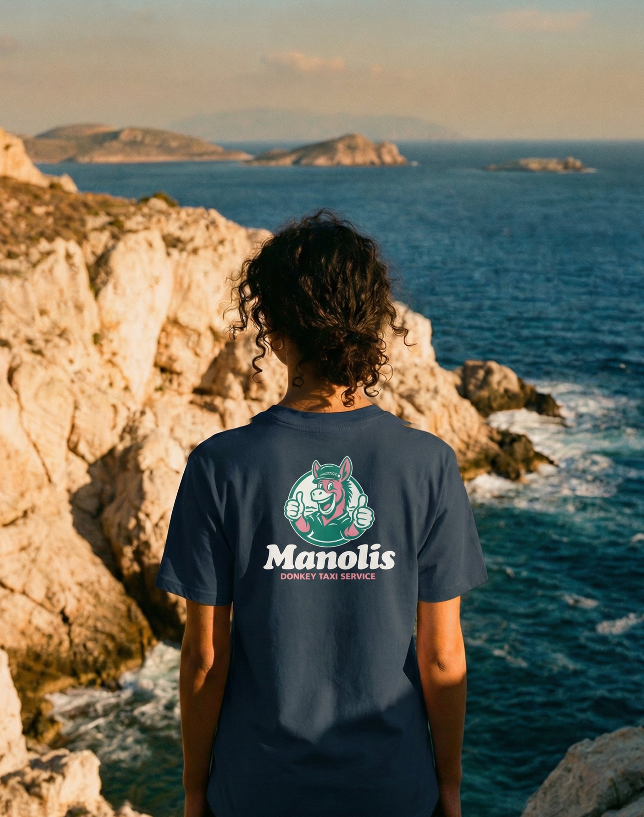 Manolis Donkey Taxi Service Club black T-shirt shot with Mediterranean backdrop in Greece— PERAMA Sponsors