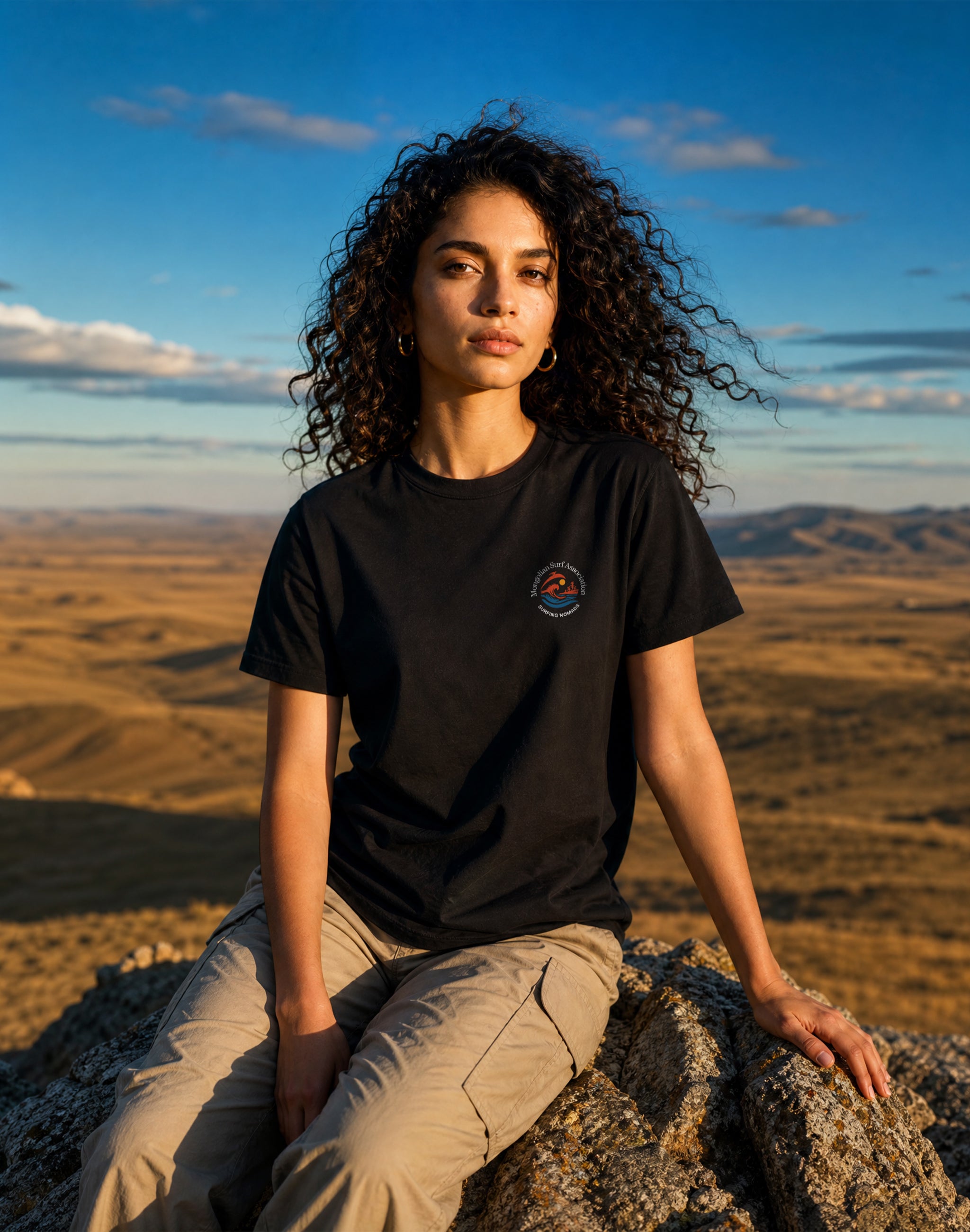 Mongolian Surf Association uniform female model wearing black t-shirt back print in Mongolian mountains — PERAMA Sports Federation