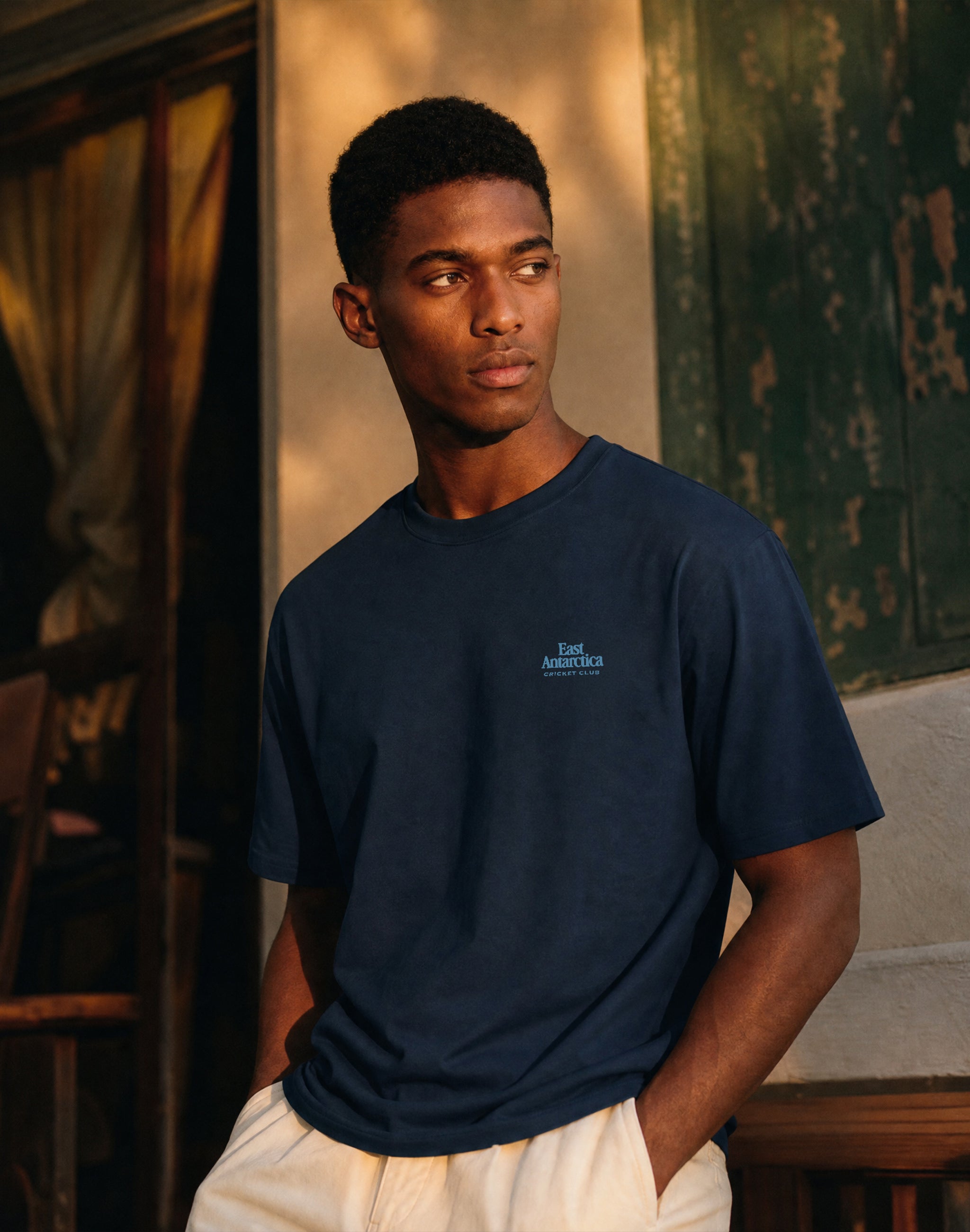 East Antarctica Cricket Club heritage french navy T-shirt chest
print worn by male model — PERAMA Federations