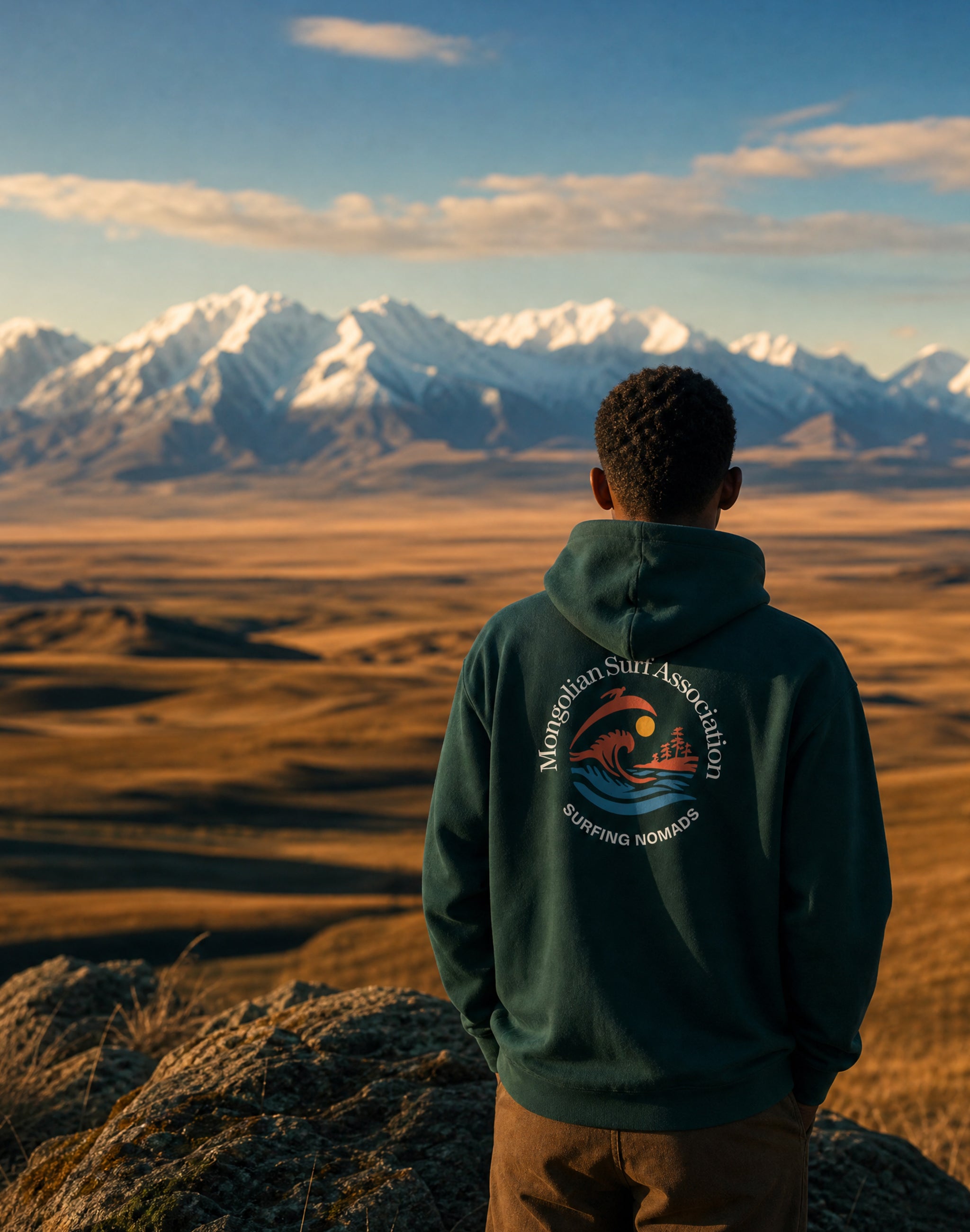Mongolian Surf Association pine green hoodie worn by male model in vast Mongolian landscape — PERAMA Sports Federation
