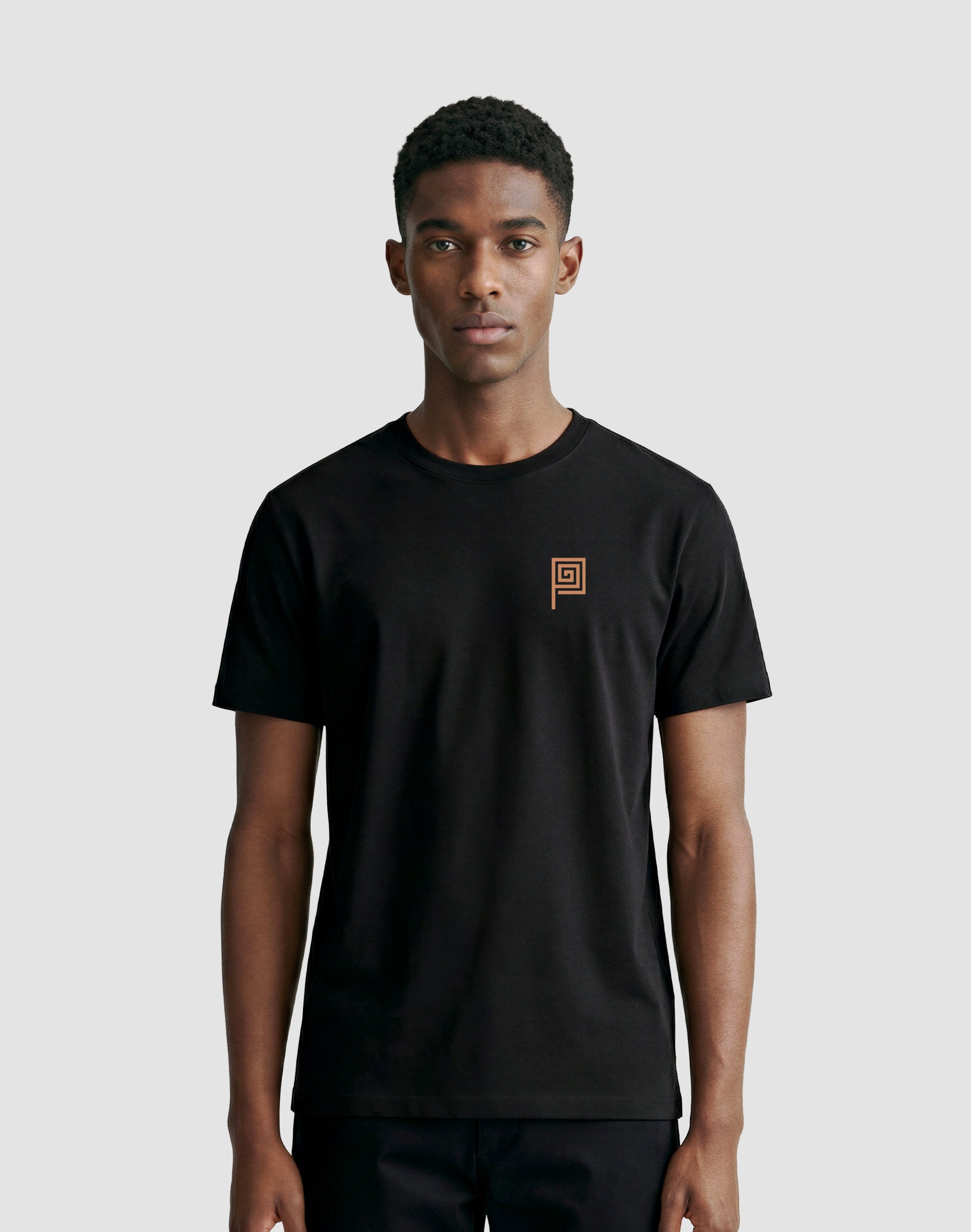 The Meander black t-shirt worn by male model in studio — PERAMA Classics