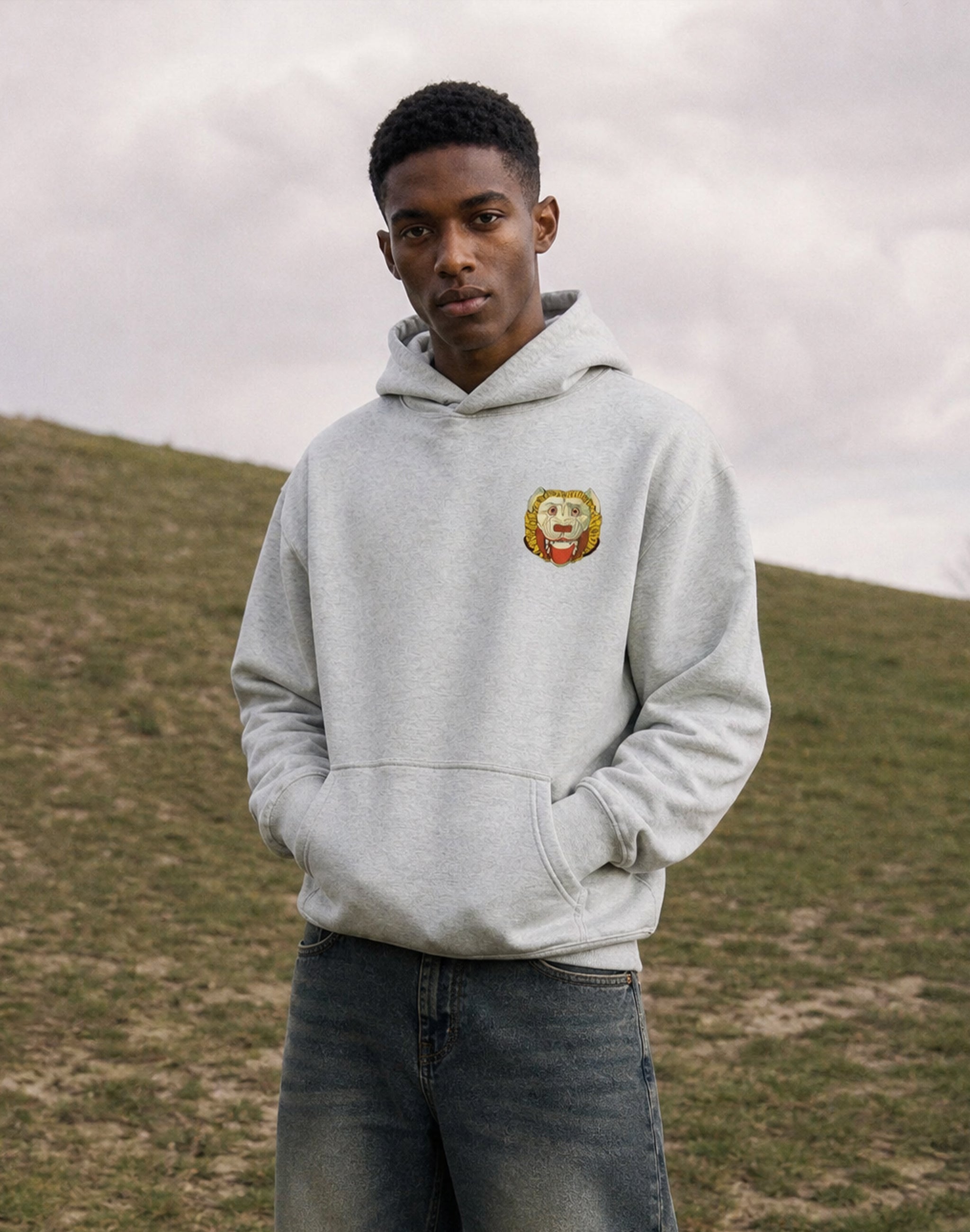 Thespis Hoodie front black worn by male model on a hill in the park— PERAMA Classics