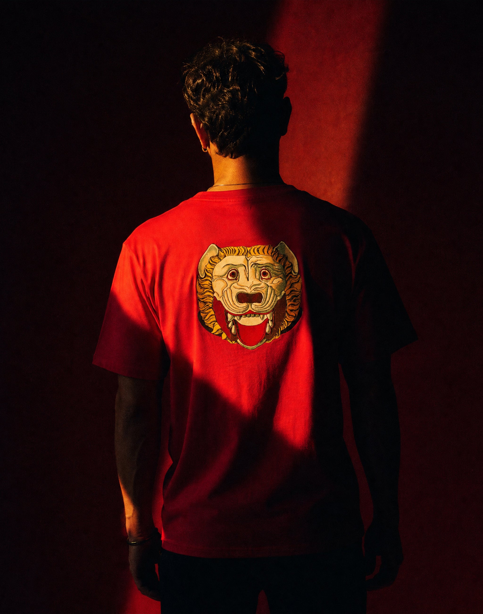 thespis-red-back-male-model-lifestyle theatre red background — PERAMA Classics